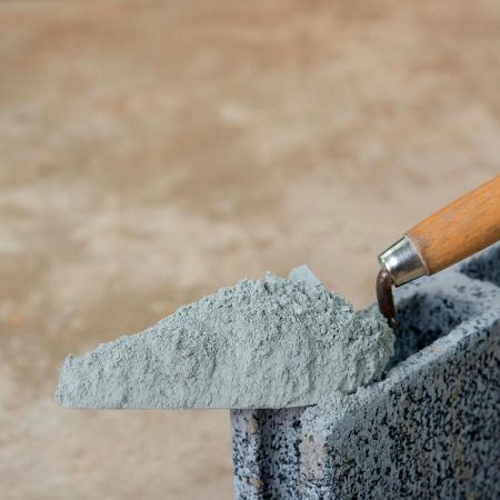cement-powder-or-mortar-with-trowel-put-on-the-concrete-brick-for-construction cement-powder-or-mortar-with-trowel-put-on-the-concrete-brick-for-construction